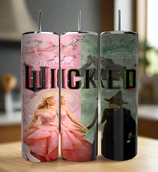 The Kreative Kreationz Wicked 20oz Tumblers set includes three tall, stainless steel insulated tumblers with bold "WICKED" lettering, adorned with pink floral motifs and vibrant character designs inspired by the musical "Wicked," set against a blurred indoor backdrop.