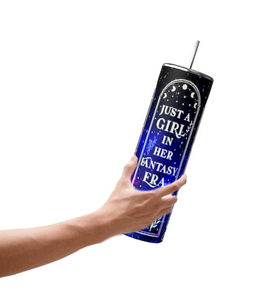 A hand holds the stylish Just a Girl 20oz Tumbler by Kreative Kreationz, featuring a dark blue design with a spill-proof lid and straw. The tumbler is decorated with stars and the phrase 