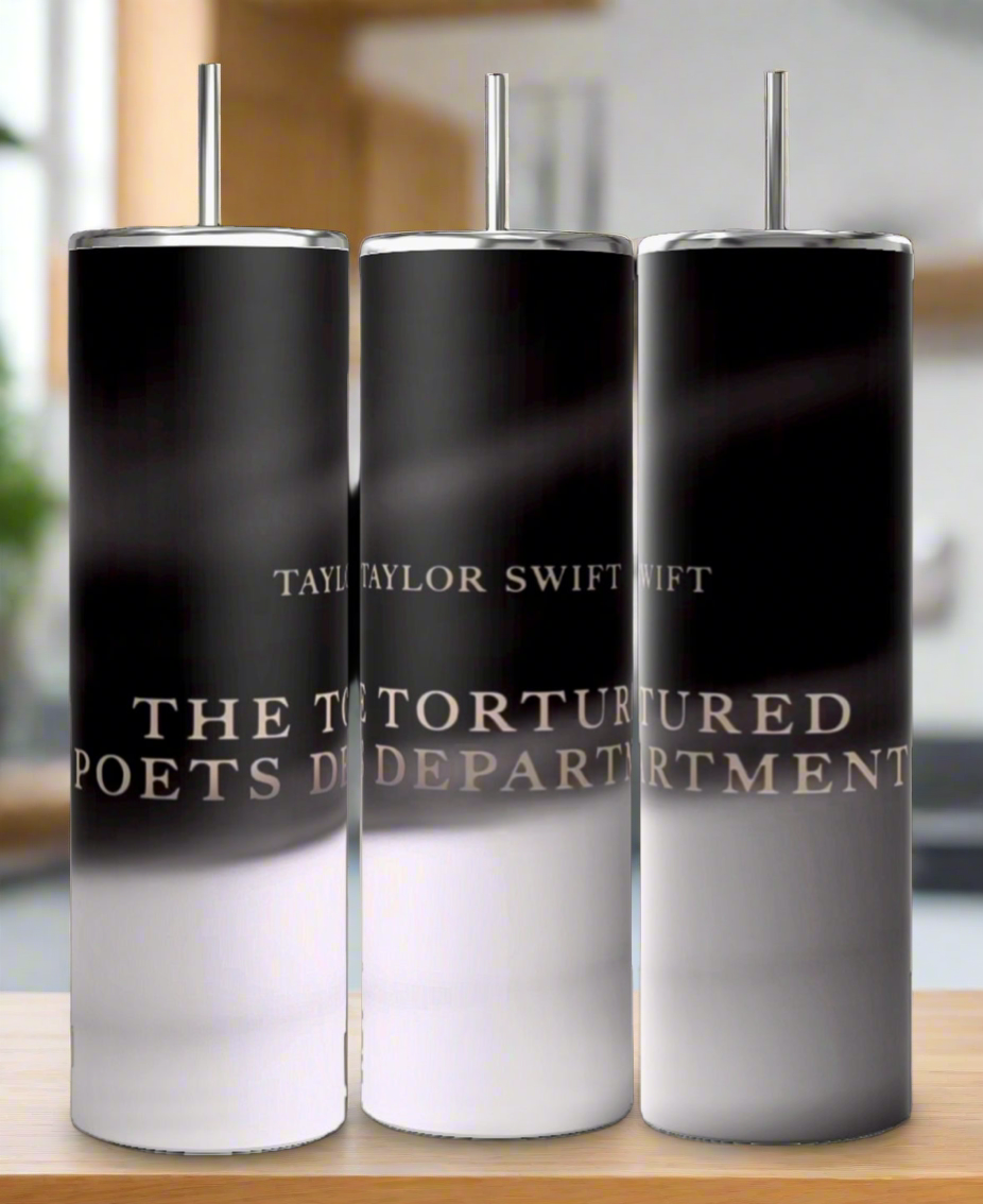 Three 20oz TTPD tumblers by Kreative Kreationz, featuring black and white gradients with metal straws, display "TAYLOR SWIFT THE TORTURED POETS DEPARTMENT" text. They're shown side by side on a blurred background.