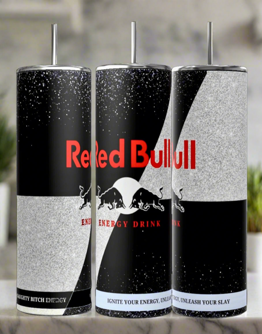 Three "Red Bull" energy drink cans featuring a unique custom design and sturdy build. The iconic red emblem is complemented by stylish black and silver motifs, along with slogans such as "Energy Drink" and "Ignite Your Energy, Unleash Your Slay," creating an elegant appearance akin to the Black Edition 20oz Tumbler by Kreative Kreationz.