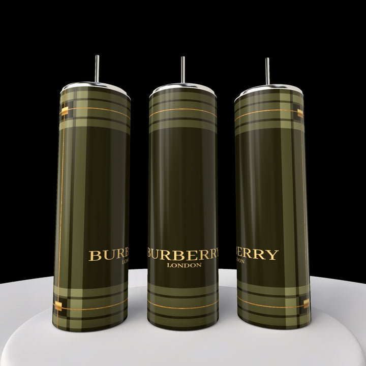 Three tall, green Kreative Kreationz Burberry 20oz Skinny Tumblers with silver lids and reusable straws are displayed on a white surface. Each has a plaid design with "Burberry London" in gold on the front, featuring double-wall insulation. The background is black.