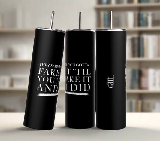 Three Gotta Fake It | TTPD 20oz Tumblers by Kreative Kreationz with black stainless steel bodies and silver lids and straws are placed side by side. The front tumbler reads, "They said: Babe, you gotta fake it 'til you make it and I did," in white text. The middle tumbler displays part of a logo with the letters "TWD." Each features a spill-proof lid.