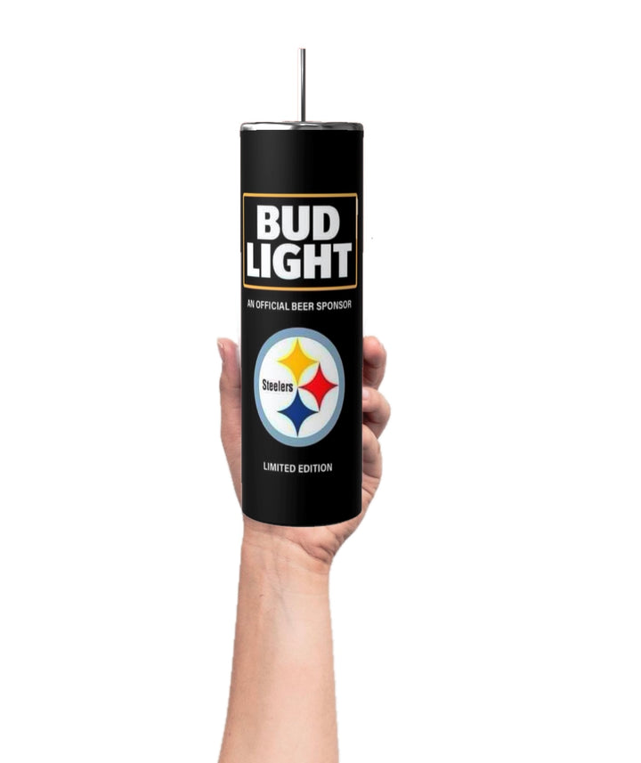 A hand holds a Kreative Kreationz 20oz Pittsburgh Steelers NFL skinny tumbler, featuring a Bud Light logo and labeled "Official Beer Sponsor" and "Limited Edition," with a reusable straw against a plain white background.