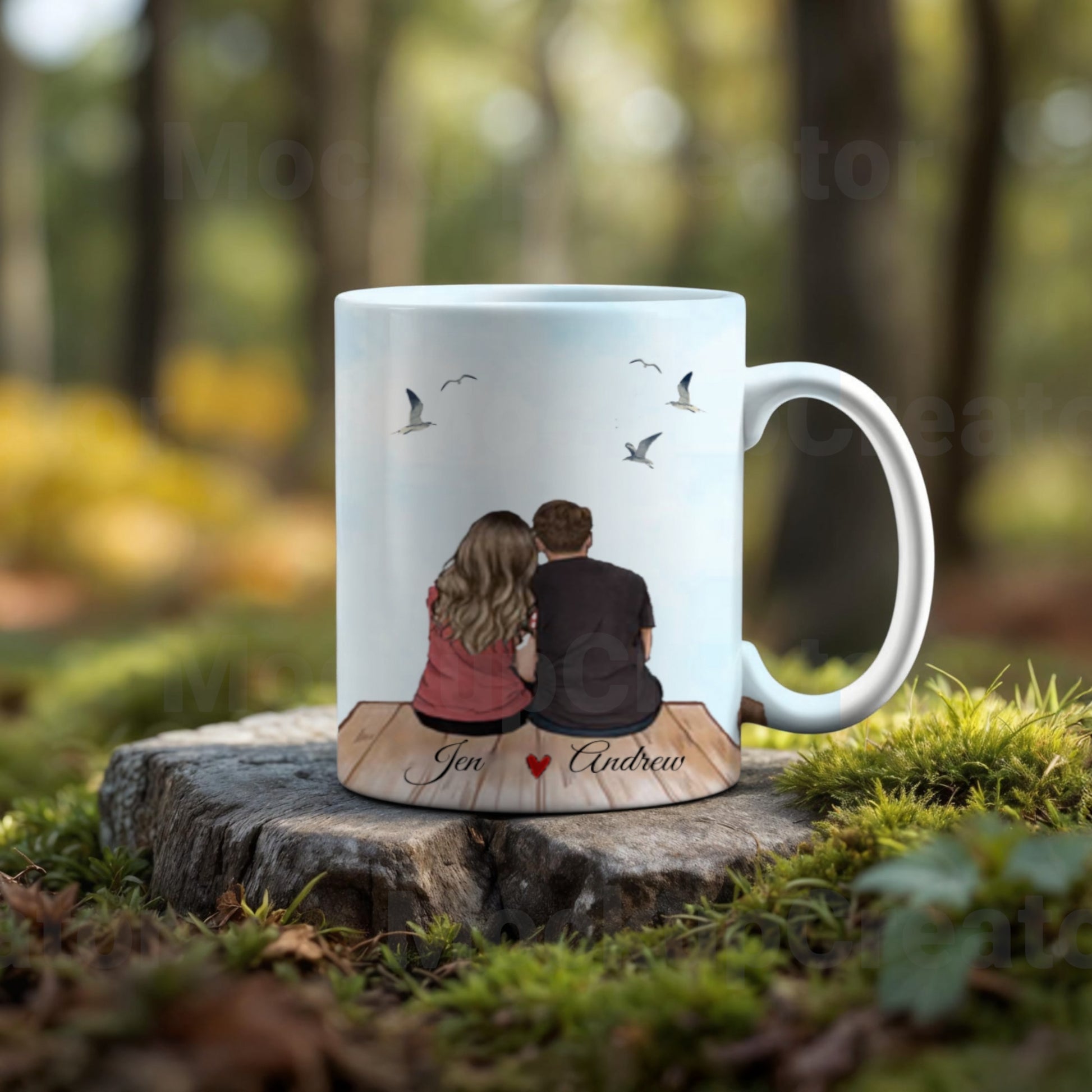 The Personalized Couples Ceramic Mug by Kreative Kreationz features an illustration of a couple on a dock with birds in the background. "Jen ♥ Andrew" appears below, making it a thoughtful gift with various customization options available.