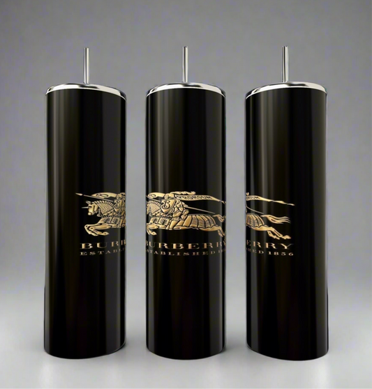 The Burberry 20oz Skinny Tumblers by Kreative Kreationz feature three elegant black cylindrical designs with silver accents and a gold Burberry logo, including "Established 1856" and an equestrian knight. They offer double-wall insulation for perfect temperature and come with a reusable straw.