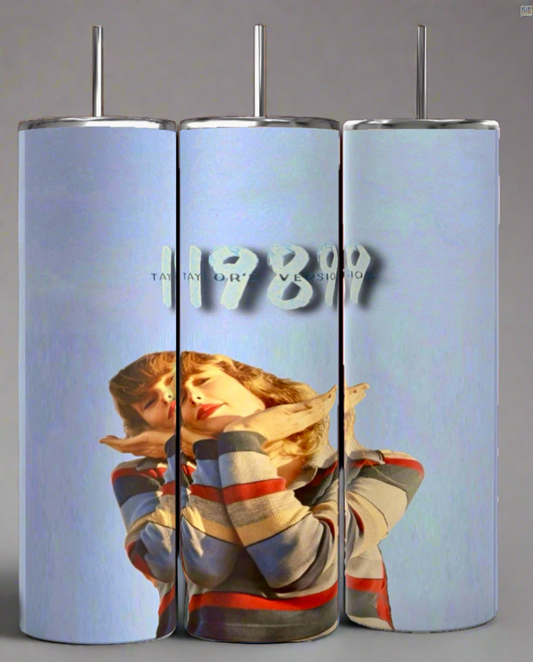 Kreative Kreationz offers three 1989 20oz Tumblers showcasing a design of a person in a striped shirt on a light blue background with "1989" and partial text. Each tumbler includes a spill-proof lid for convenience.