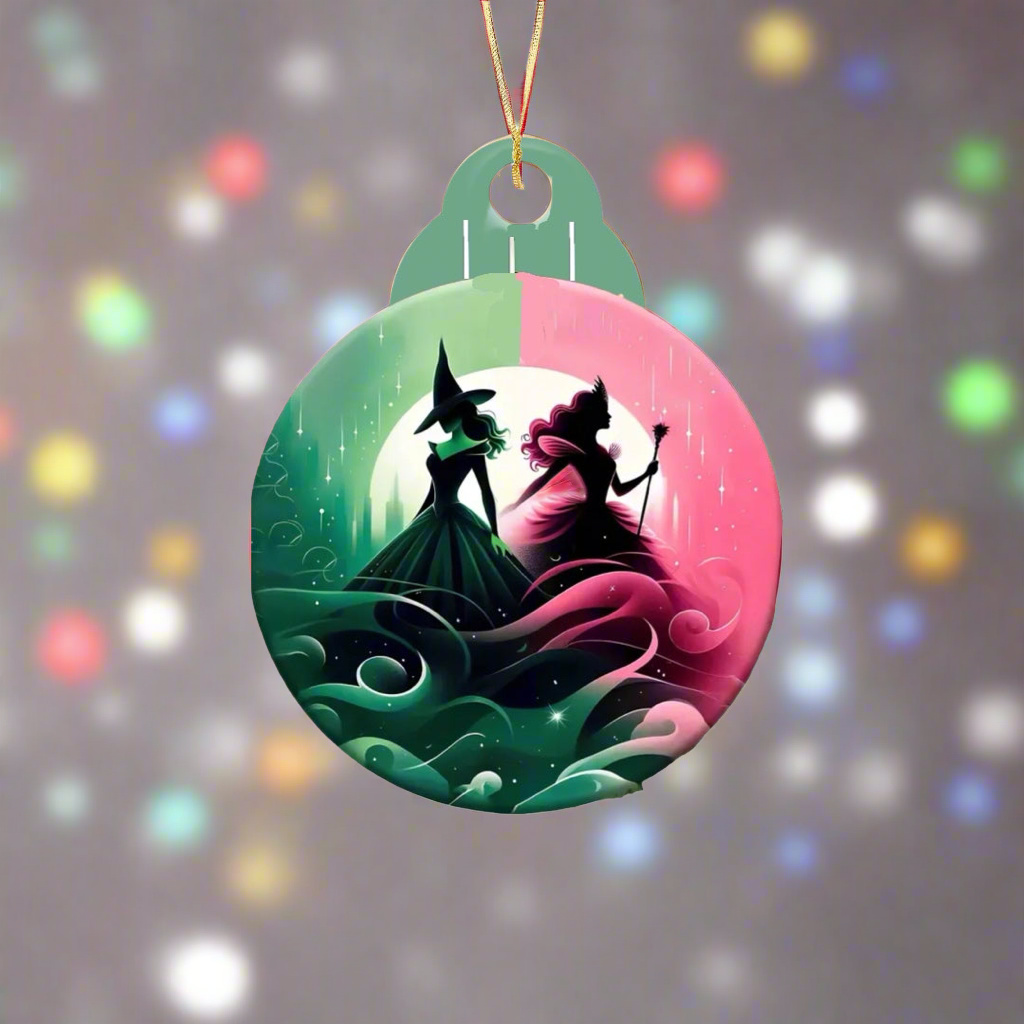 Introducing the Wicked Christmas Tree Ornament from Kreative Kreationz: a stunning round creation featuring a sublimated design of two witch silhouettes—one in green, the other in pink—set against an enchanting moonlit, swirling background. It elegantly suspends from a string amid the glow of colorful holiday lights.