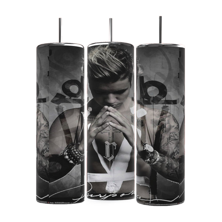 Three cylindrical Justin Bieber Prayer 20oz Tumblers by Kreative Kreationz feature monochrome images of a contemplative Justin Bieber, adorned with tattoos and wearing a sleeveless shirt and several bracelets. His hands are pressed together in a prayer-like gesture, with the word "Purpose" visible at the bottom. These tumblers keep beverages hot or cold.