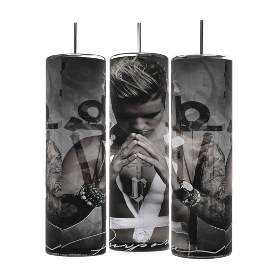 Three cylindrical Justin Bieber Prayer 20oz Tumblers by Kreative Kreationz feature monochrome images of a contemplative Justin Bieber, adorned with tattoos and wearing a sleeveless shirt and several bracelets. His hands are pressed together in a prayer-like gesture, with the word 