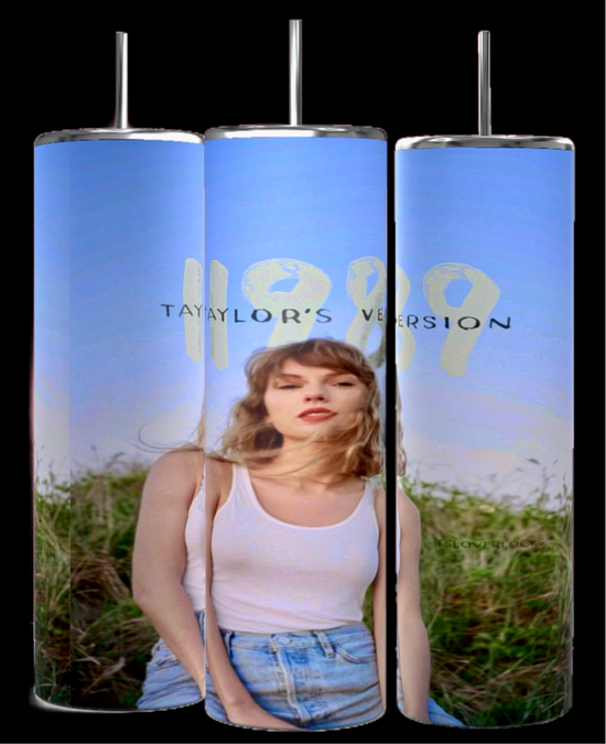 A person in a white tank top and jeans stands before greenery under a clear blue sky, holding an eye-catching Kreative Kreationz 1989 Taylor's Version Tumbler. The vibrant photographic design covers all three cylindrical tumblers, each with a 20 oz capacity.