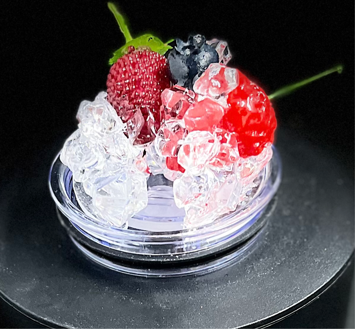 A slice of lime sits atop a pile of crushed ice, elegantly displayed on a small, round, clear platform against a beige background that accentuates the lime and ice. A black strip at the bottom features white text reading "3D Lid Topper for standard 20oz Tumbler." This setup by Kreative Kreationz is an ideal accessory for any tumbler.