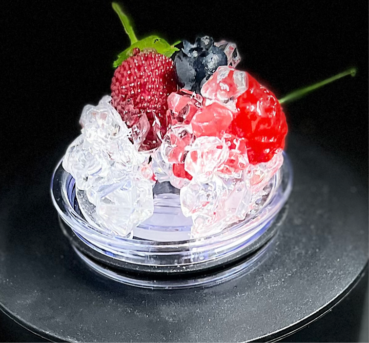 A slice of lime sits atop a pile of crushed ice, elegantly displayed on a small, round, clear platform against a beige background that accentuates the lime and ice. A black strip at the bottom features white text reading "3D Lid Topper for standard 20oz Tumbler." This setup by Kreative Kreationz is an ideal accessory for any tumbler.