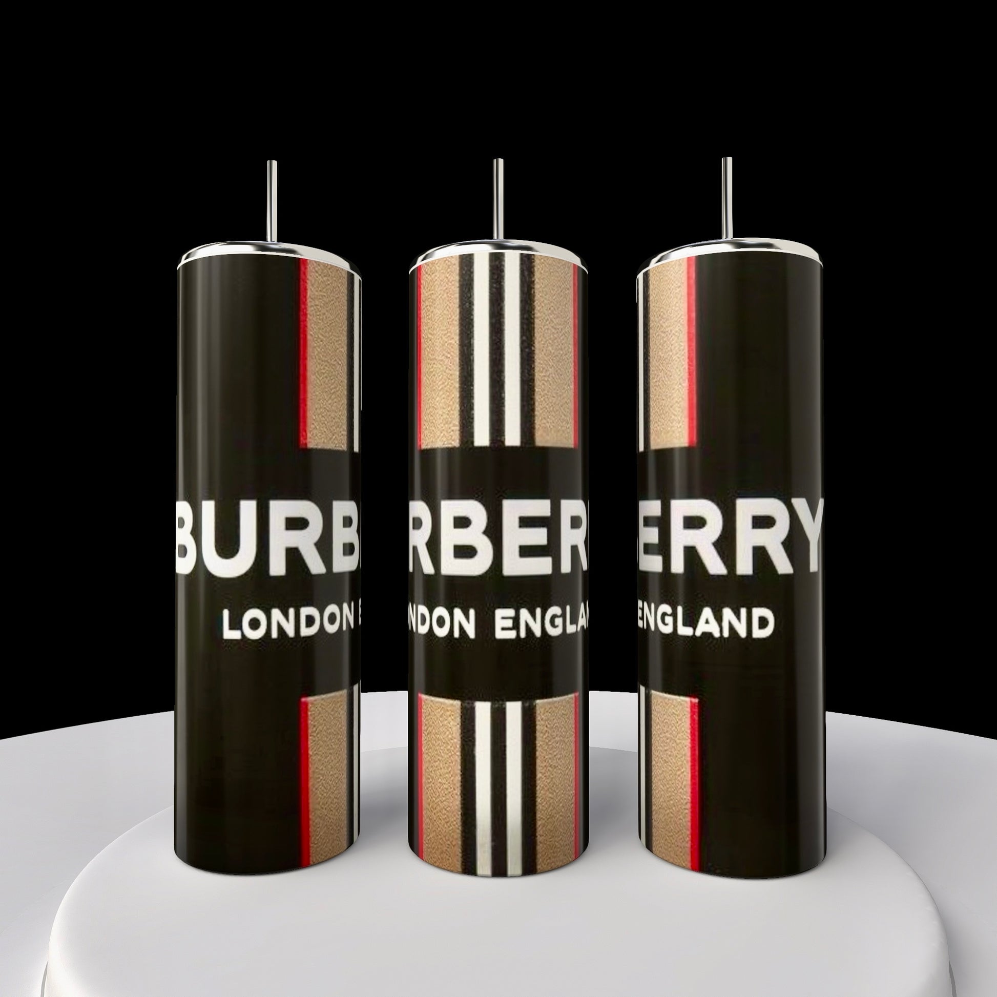 Three 20oz skinny tumblers with a black, beige, and red design bear the brand name "Burberry London England" on their surface. These Kreative Kreationz creations feature durable rubber bottoms and are arranged against a contrasting black background.