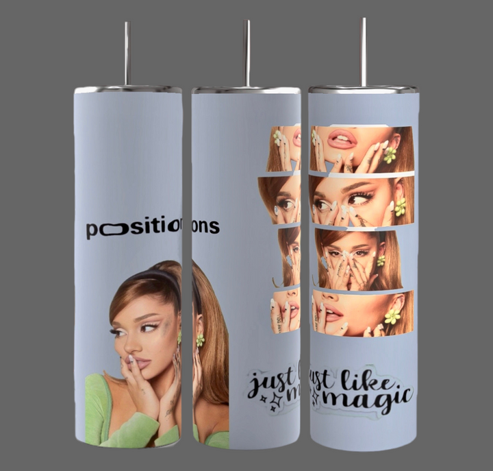 Three tall, cylindrical tumblers are arranged side by side. These Ariana Grande 20-ounce Skinny Tumblers from Kreative Kreationz feature images of a seated woman wearing green and holding her chin. One reads "positions," another says "just like magic," while the rightmost has multiple close-up shots of the woman's face.