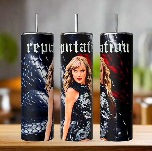 Three "REP | Snake | Tumbler" by Kreative Kreationz sit on wood, each depicting a blonde woman, snake pattern, and "reputation" in stylized font. The backdrop is dark with red tones and silver straws adorn the skinny tumblers.