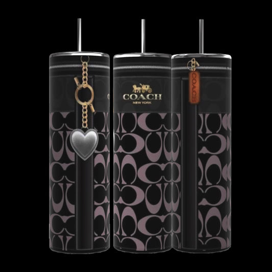 A trio of Coach Heart Designed 20oz Tumblers from Kreative Kreationz, each featuring a cylindrical shape with a black and gray Coach pattern. These tumblers have contrasting black stripes and are adorned with different charms: a silver heart, a gold Coach logo, and a brown tag inscribed with "Coach." They boast durable construction and come complete with black lids and straws.