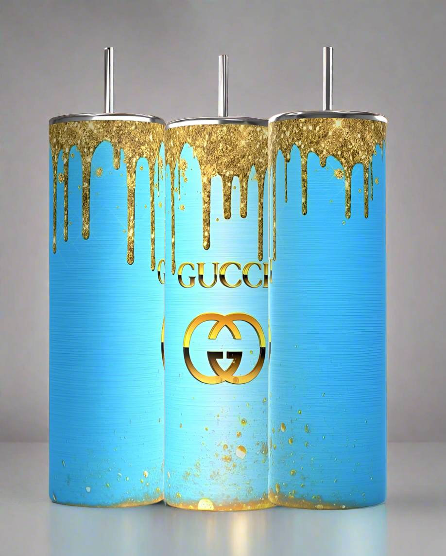 Three Kreative Kreationz Gucci Blue Drip 20oz Tumblers with spill-proof silver lids and straws are displayed, each featuring a blue background with gold paint drips and a striking gold logo inspired by a luxurious GUCCI aesthetic.