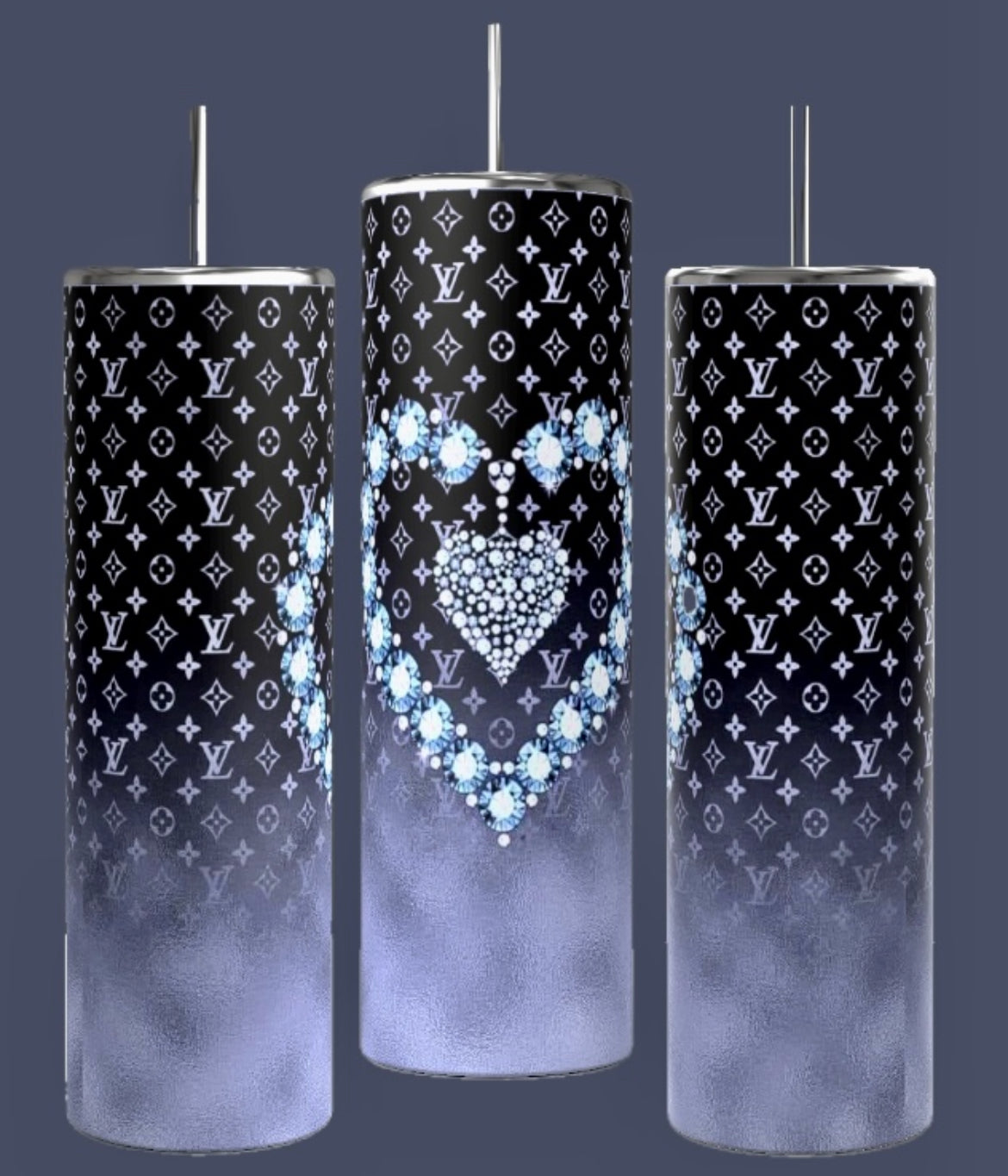 Three LV Designer 20oz Tumblers by Kreative Kreationz feature a tall, cylindrical design with spill-proof metallic lids and straws. They showcase a black and white designer pattern, with the middle tumbler adorned with a heart design crafted from blue flowers. Each tumbler transitions to a gradient foggy gray towards the bottom.