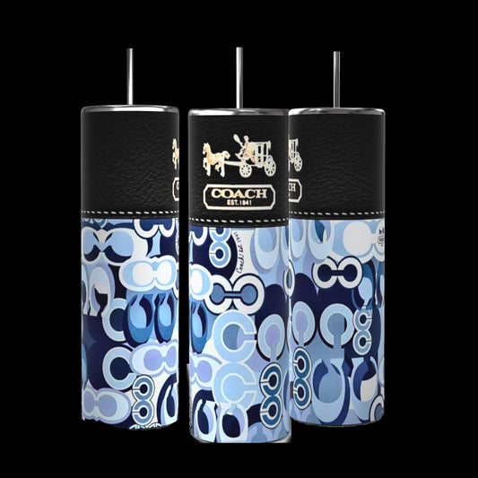 Three Coach Purse 20oz Tumblers from Kreative Kreationz showcase a sublimated design featuring the Coach logo in blue, white, and black. Each tumbler is equipped with a spill-proof black lid and a silver straw, maintaining a consistent pattern throughout.