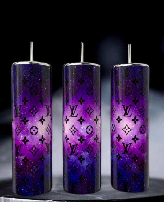 Kreative Kreationz's LV Cosmo 20oz Skinny Tumblers are three tall, double-wall stainless steel tumblers with reusable metallic straws, featuring a purple galaxy design and sleek black logos on a dark background. They're perfect for stylishly enjoying your favorite drinks on the go.