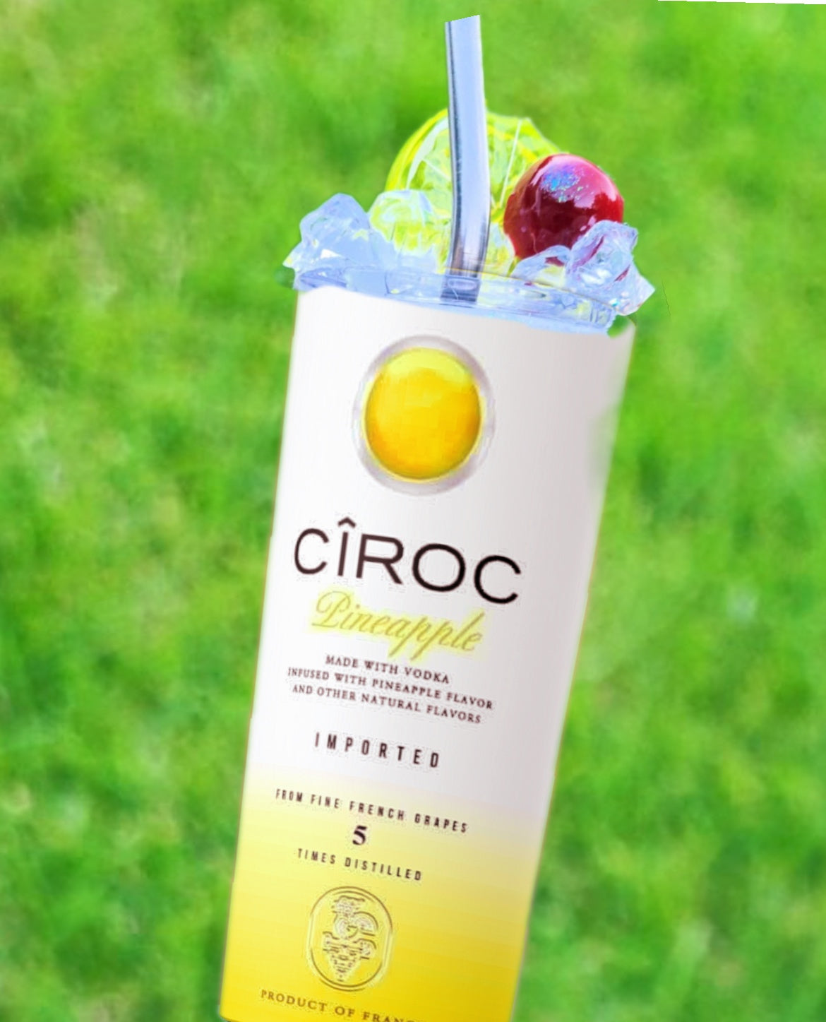 Two cans of Kreative Kreationz Ciroc 20oz Tumbler with 3D Lid Topper are shown on a wooden surface, reminiscent of travel tumblers. The left can is Red Berry flavor, topped with ice and a cherry. The right can is Vodka Snap Frost flavor, topped with ice and a lemon slice. Both cans feature product information and branding.