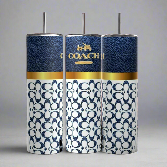 Three Coach-inspired dark blue 20oz tumblers from Kreative Kreationz, each accompanied by a metal straw, are displayed. These tumblers showcase a textured dark blue upper section featuring the 