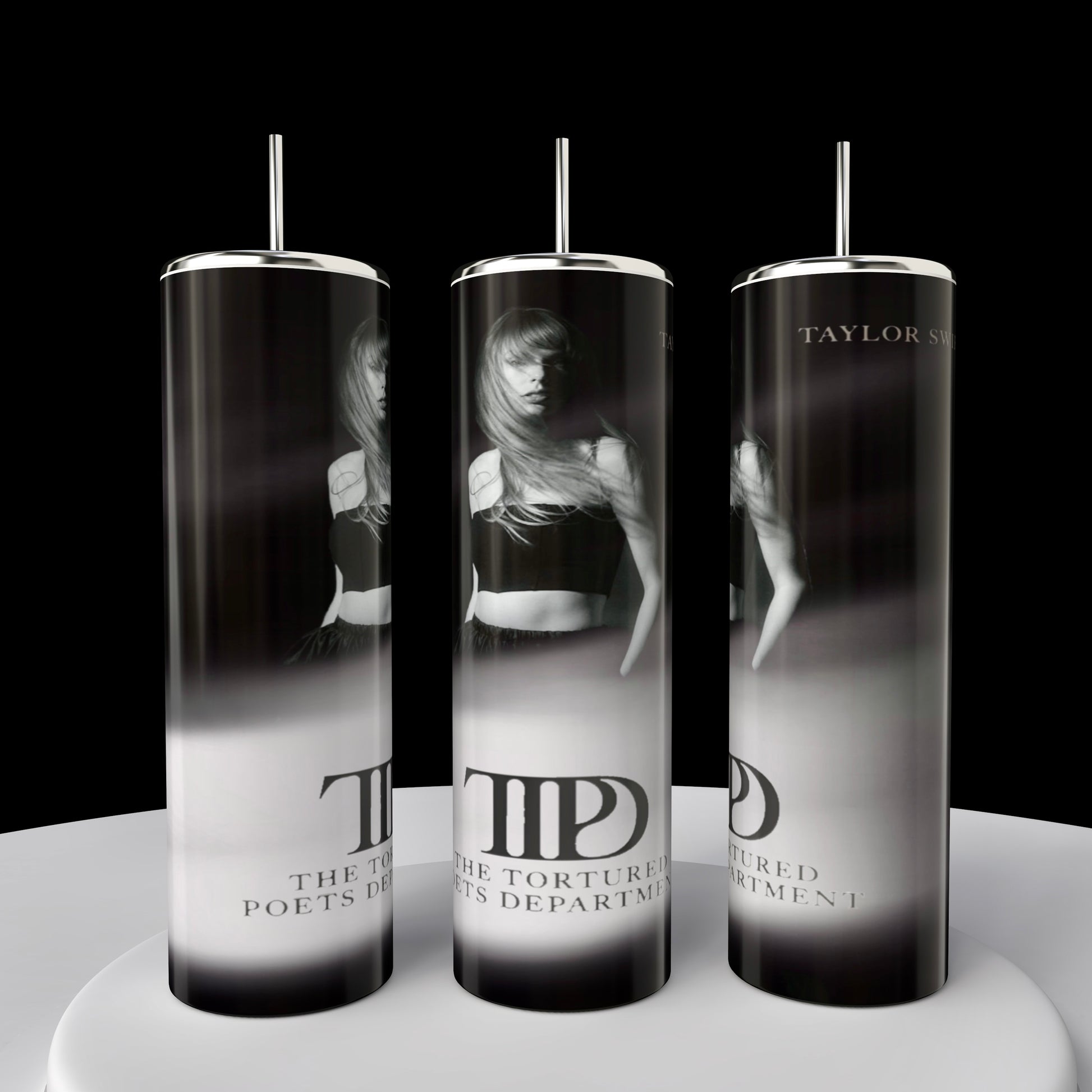 The TTPD | Tumbler by Kreative Kreationz features three 20oz Skinny Tumblers adorned with black-and-white images of a person and text reading "The Tortured Poets Department" and "Taylor Swift." Set against a black background, these insulated tumblers include metal straws for optimal drink temperature.