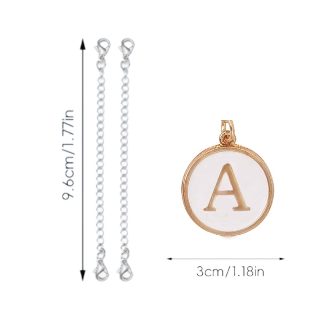 An image showcasing the Monogram Charm Dangle by Kreative Kreationz, featuring two silver chains with lobster clasp closures and a gold-colored personalized pendant with the letter "A." The chains are 9.6 cm (1.77 in) long, and the eye-catching pendant measures 3 cm (1.18 in) in diameter.