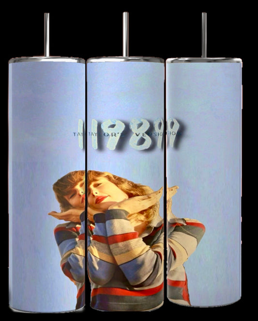 The "1989 20oz Tumbler" set by Kreative Kreationz includes three sublimated tumblers featuring a stylized figure with hands near the face, minimalist "1989" and "Taylor" text on a blue background. Each tumbler has a spill-proof lid for convenience.