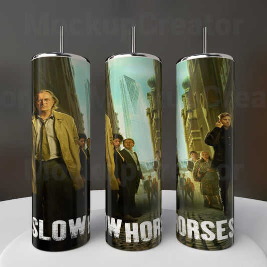 The Kreative Kreationz "Slow Horses" 20oz Stainless Steel Tumbler features three sublimated cylindrical displays of an urban scene with people and tall buildings, text "SLOW HORSES," on a dark, warm-toned background.