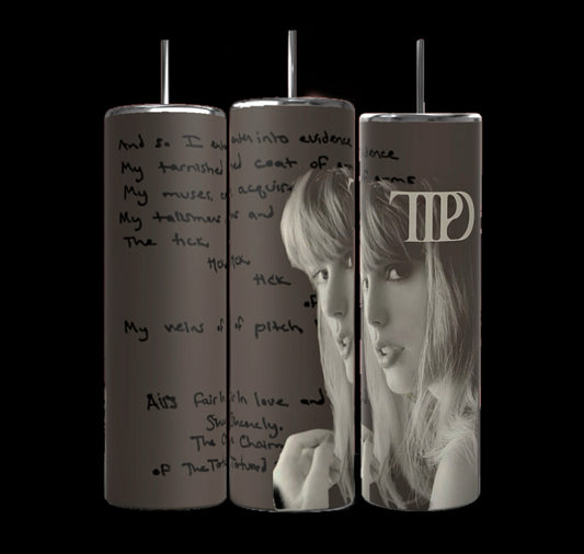 A set of three TTPD The Manuscript 20oz Tumblers by Kreative Kreationz featuring a grayscale image of a woman with long hair and bangs. One tumbler proudly displays a stylized "TAYLOR's Version" logo. The durable construction keeps beverages hot or cold, while handwritten text provides an artistic background.