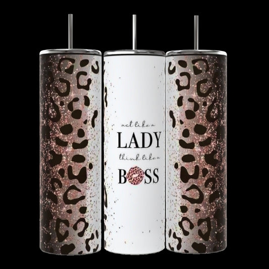 Three tall, cylindrical Boss Lady 20oz Tumblers with metal straws and white backgrounds from Kreative Kreationz. The first stylish tumbler displays motivational words like "She," "Motivates," "Inspires," and "Empowers" in black, pink, blue, and yellow fonts. The last one features the phrase "BOSS LADY" in bold pink and blue letters. Durable construction ensures lasting use.