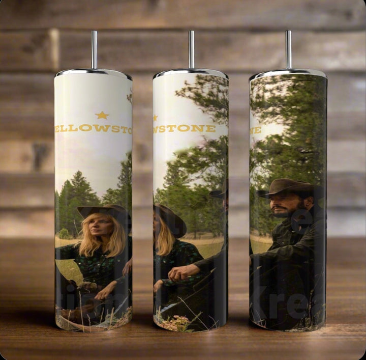 Three Yellowstone 20oz Tumblers by Kreative Kreationz are showcased on a wooden surface. Each stainless steel cylinder displays images of people in hats against trees and sky, with "Yellowstone" printed on them.