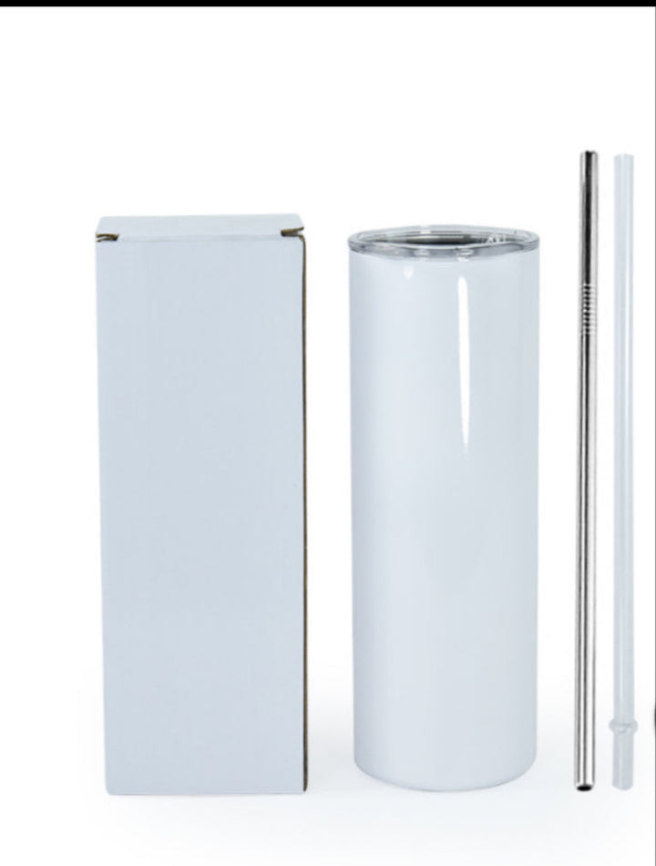 A sleek, white Kreative Kreationz Yellowstone 20oz Tumbler with a transparent lid sits beside a plain box. Next to the stainless steel tumbler are both metal and clear plastic straws, all set against a plain white background.