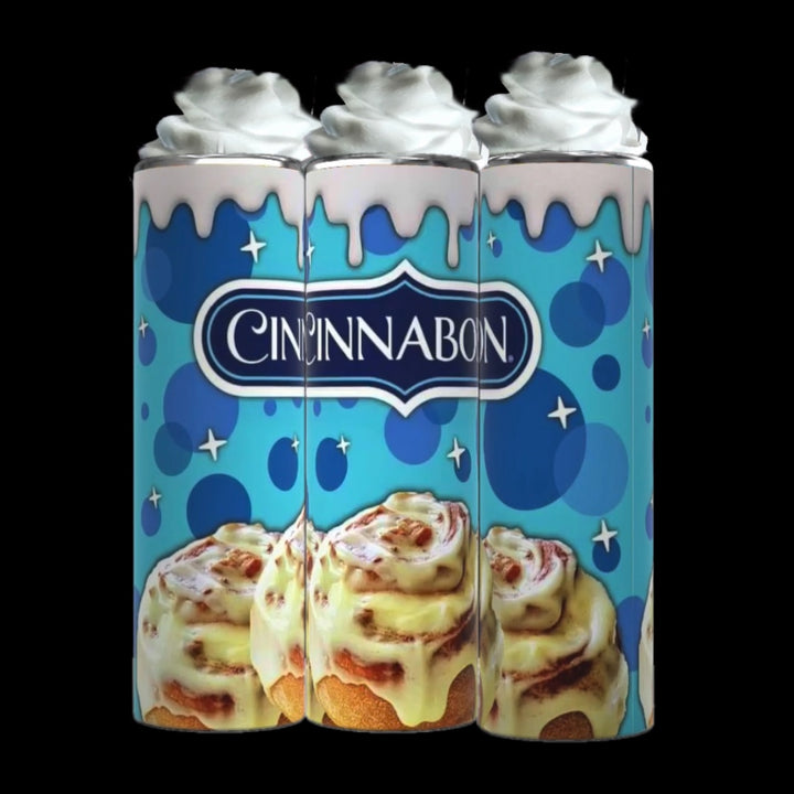 Three Kreative Kreationz Cinnabon 20oz Tumblers with Removable Lid Toppers, designed with whipped cream accents, stand side by side. The blue background showcases the Cinnabon logo and features illustrations of signature cinnamon rolls with icing dripping down the sleek design of each tumbler.