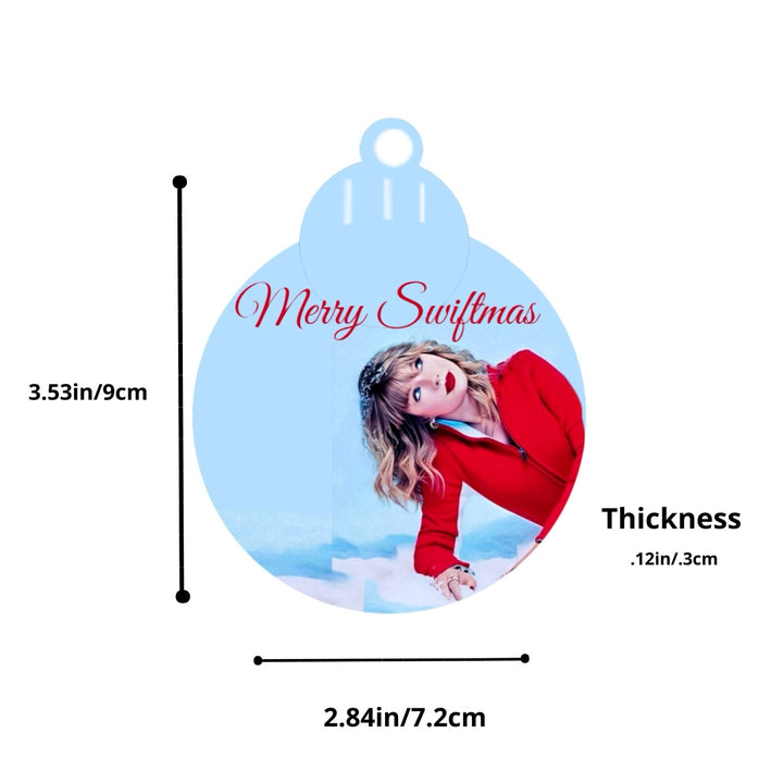 The Merry Swiftmas Tree Ornament by Kreative Kreationz features "Merry Swiftmas" elegantly inscribed and a figure in a red outfit on a snowy backdrop, making it perfect for enthusiastic festive decorators.