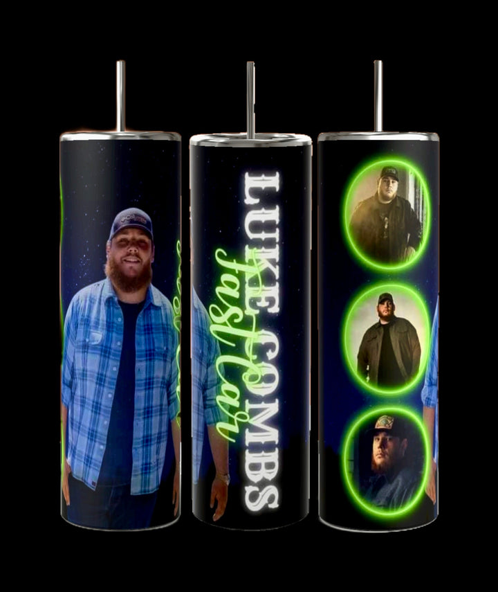 The Luke Combs 20oz Tumbler by Kreative Kreationz showcases three tall sublimated designs featuring images of a man in a cap and plaid shirt. Each design incorporates three different photos set against a dark background with green accents, along with text reading "Luke Combs" and "Fast Car." The tumbler is topped with a spill-proof lid.