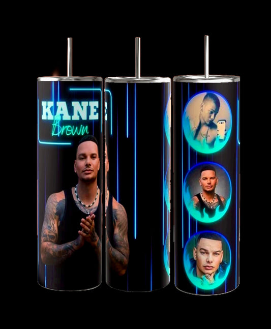 Kreative Kreationz presents the Kane Brown 20oz Tumbler, a sleek, skinny design featuring vibrant neon blue and green artwork of a tattooed man in multiple poses. The text "KANE" and "Brown" embellishes one of these uniquely designed tumblers.