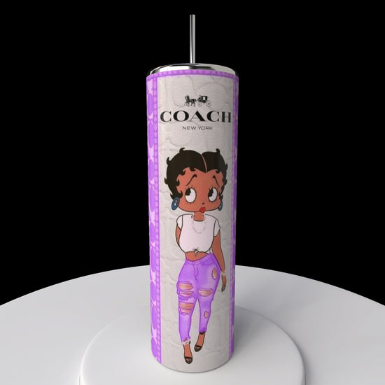 The 20oz Betty B Coach Skinny Tumbler by Kreative Kreationz features a tall design with Betty Boop in a white shirt and purple pants against a purple patterned background. It includes the Coach New York logo at the top and comes with a spill-proof lid for convenience.