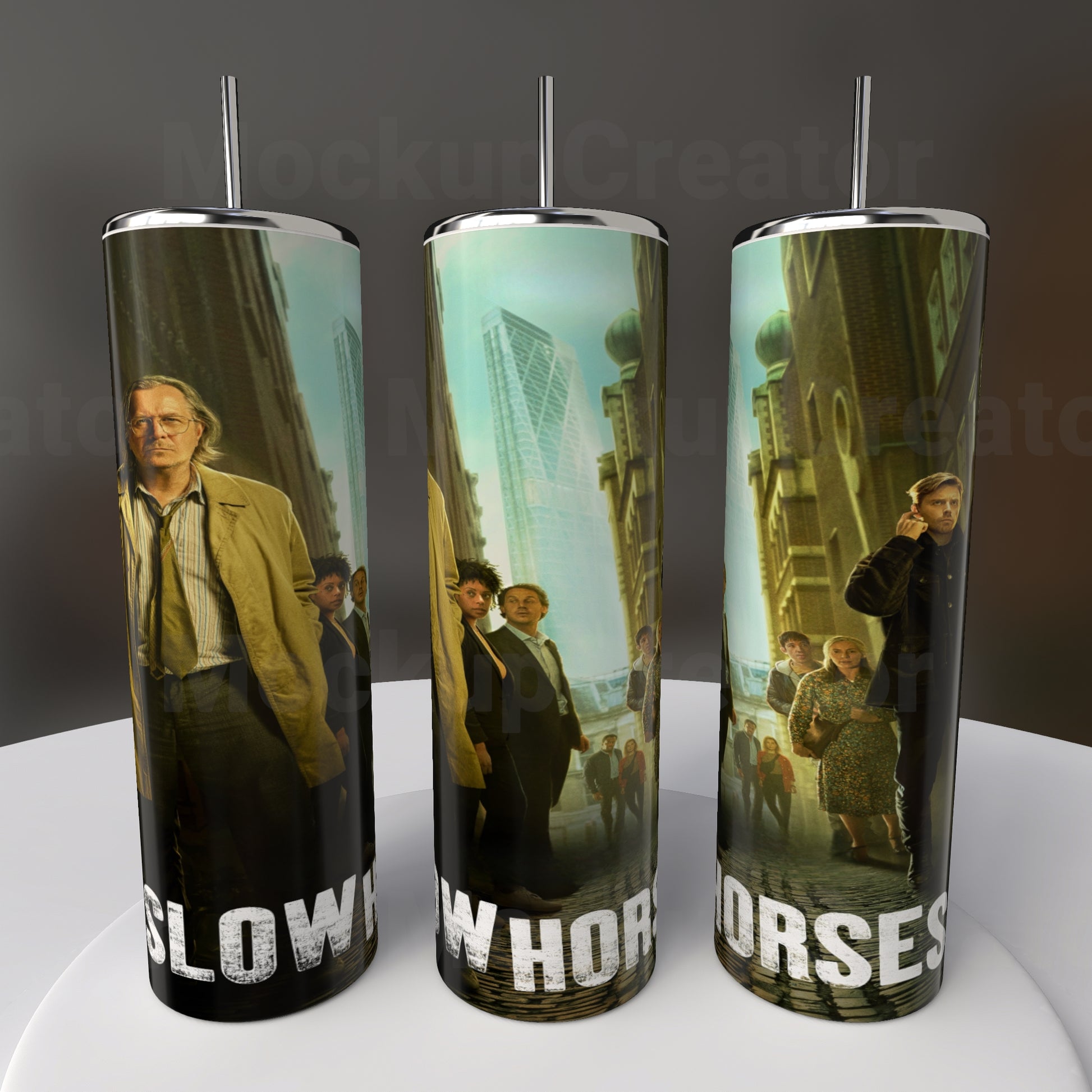 The Slow Horses 20oz Stainless Steel Tumblers by Kreative Kreationz feature urban scenes with people, cityscapes, and greenery. They prominently display the words "Slow Horses" on a tall cylindrical design.