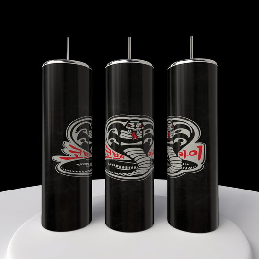 Three Kobra Kai 20oz Stainless Steel Tumblers by Kreative Kreationz, featuring a stylized cobra design and red text, stand in a row on a white circular platform against a black background.