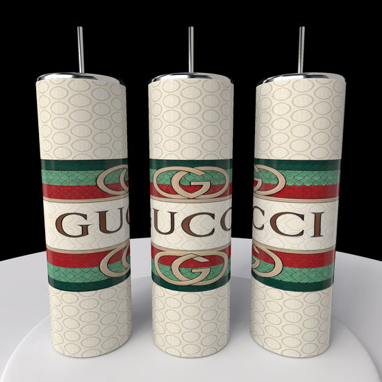 The Kreative Kreationz Gucci 20oz Tumbler showcases a repeating Gucci logo with green and red stripes on a dark background, keeping beverages hot or cold while captivating with its design.