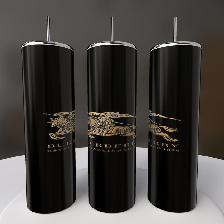 Three cylindrical black tumblers with a sleek sublimated design display a gold horse and rider logo with "Established 1856" text, labeled as Burberry 20oz Skinny Tumblers by Kreative Kreationz. Arranged on a circular white base, they feature stylish double-wall insulation.