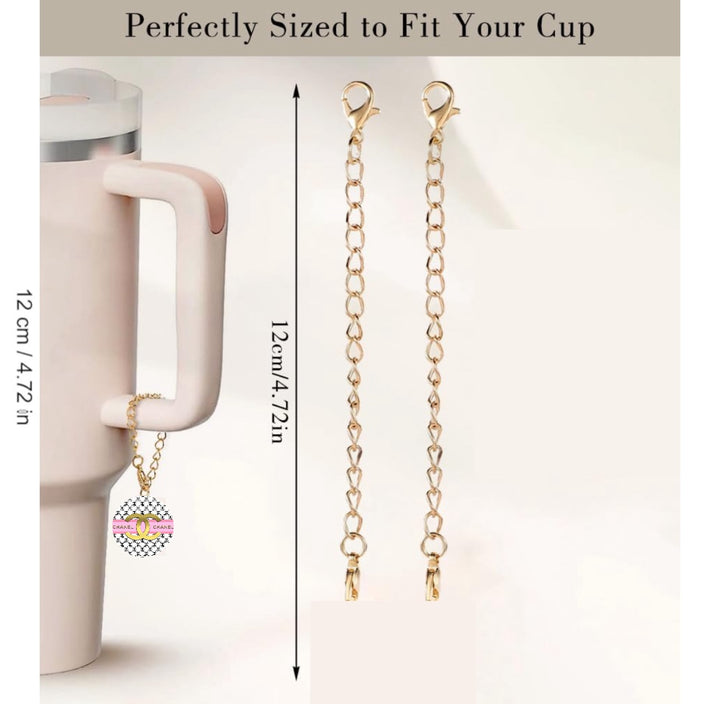 The Chanel Charm Dangle by Kreative Kreationz is a cream-colored cup accessory with a long handle and a golden chain featuring a personalized pendant. The image includes a measurement guide showing the 12 cm (4.72 inches) lobster clasp chain, described as "perfectly sized to fit your cup.